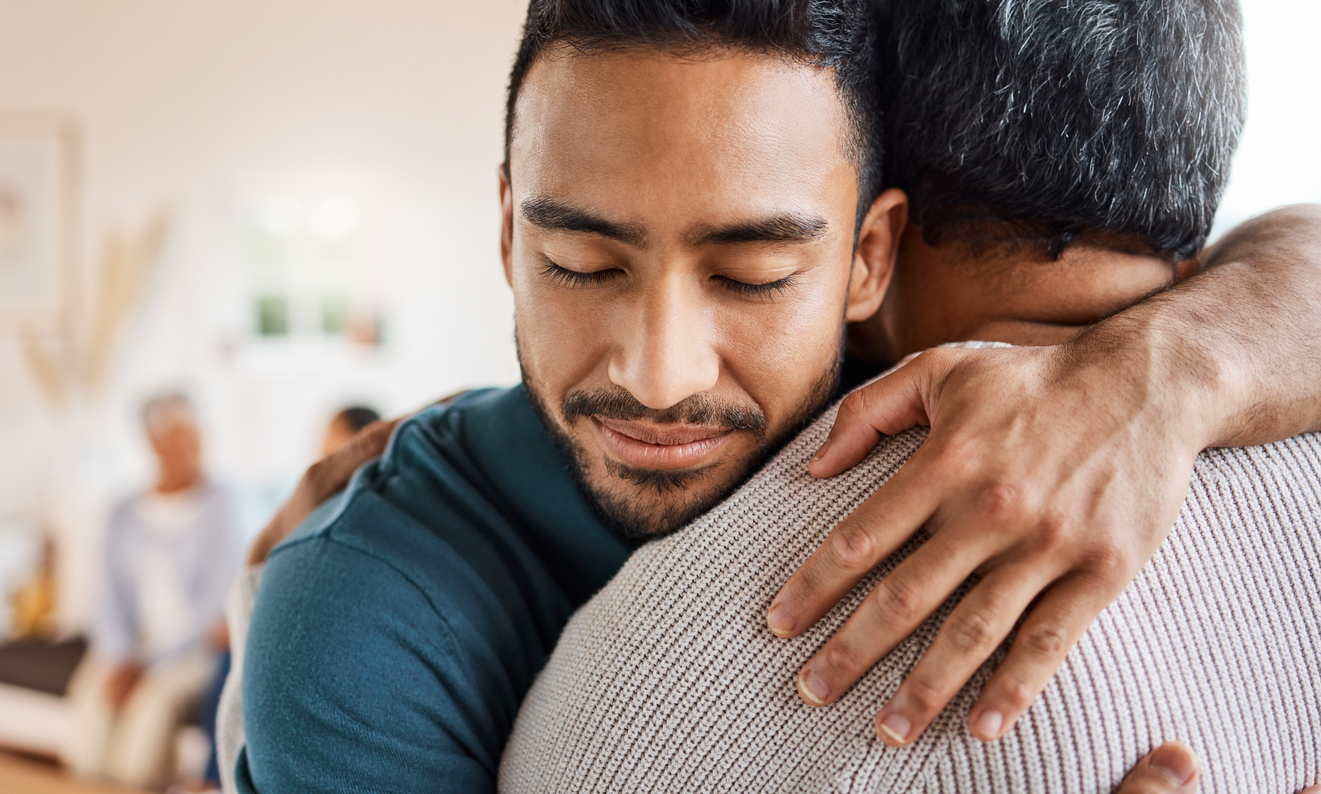 Two men hugging